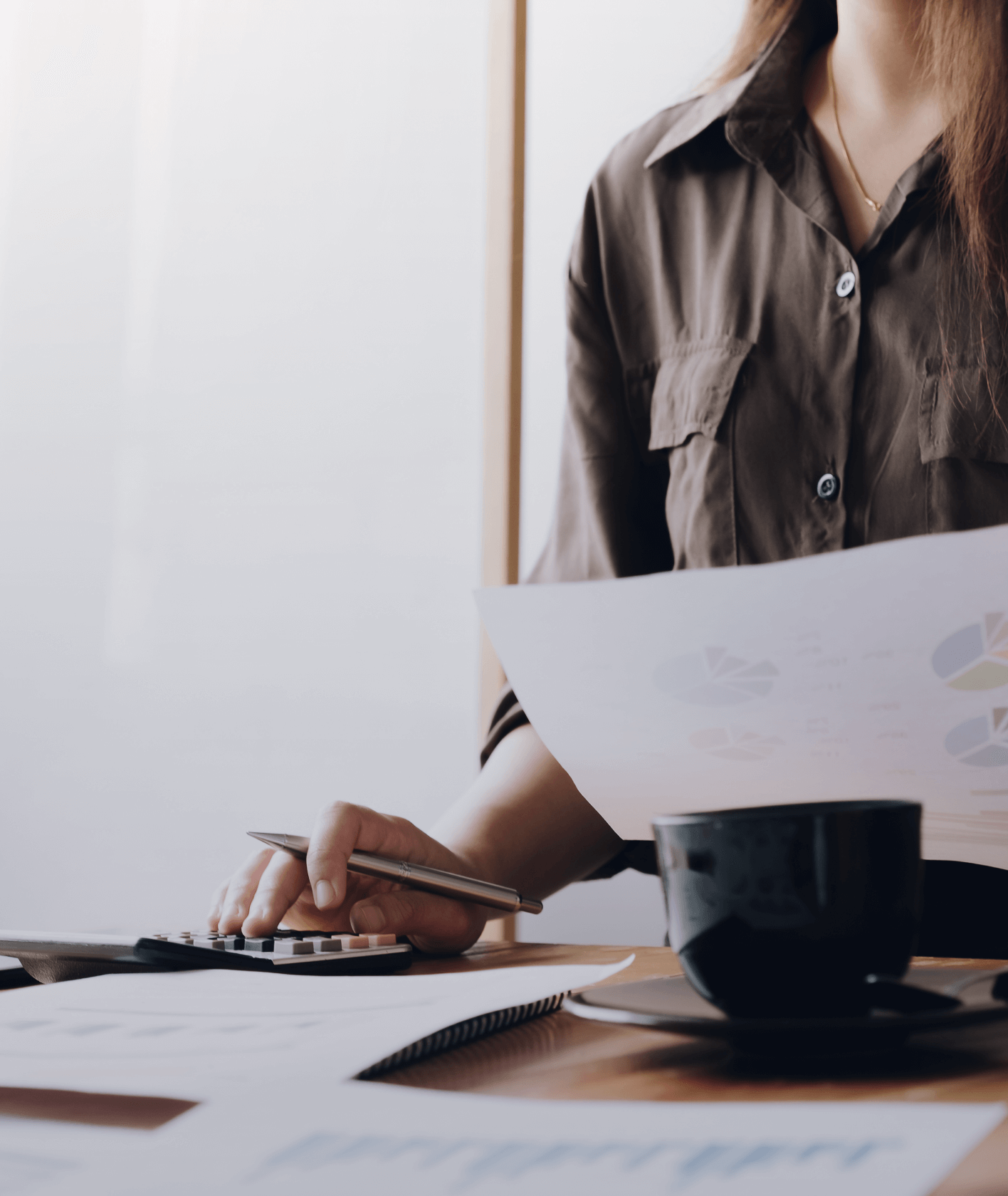 Woman working and holding financial documents